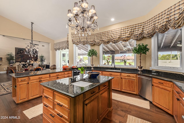 kitchen featuring dark wood-type flooring, a kitchen island, sink, and a wealth of natural light