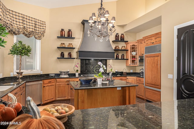 kitchen featuring hanging light fixtures, a kitchen island, backsplash, paneled fridge, and dark stone countertops