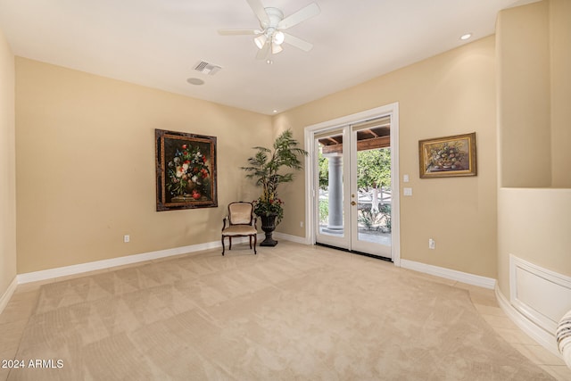 unfurnished room featuring light carpet, french doors, and ceiling fan