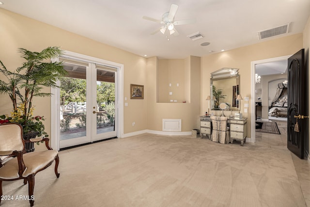 interior space featuring ceiling fan and light colored carpet