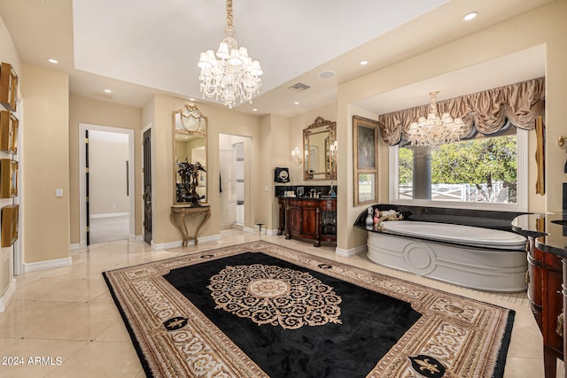 bathroom featuring vanity, tile patterned floors, a chandelier, and a tub