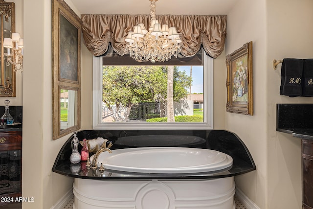 bathroom featuring a tub, plenty of natural light, and a chandelier