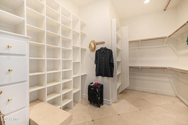 walk in closet with light tile patterned floors