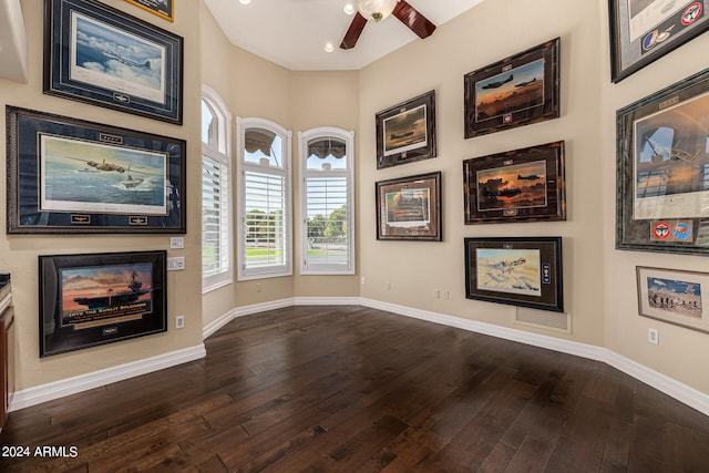 unfurnished living room with ceiling fan and dark hardwood / wood-style flooring