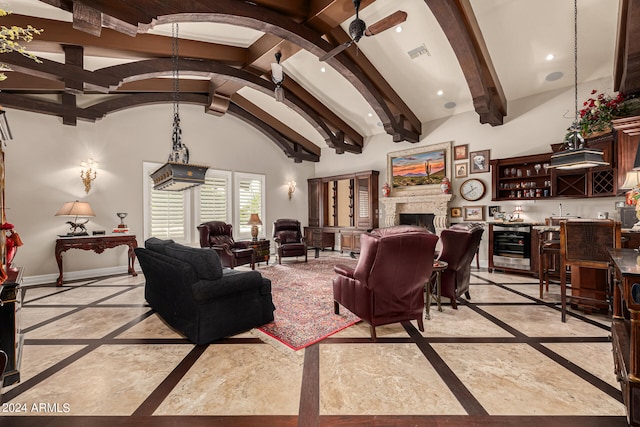 living room with ceiling fan, wine cooler, beamed ceiling, high vaulted ceiling, and bar area