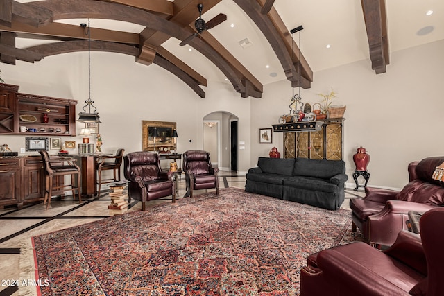 living room with beamed ceiling, high vaulted ceiling, and ceiling fan