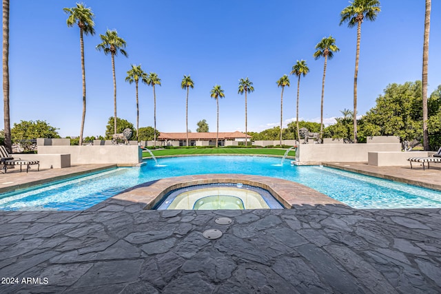 view of swimming pool with an in ground hot tub and pool water feature