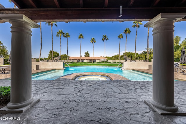 view of swimming pool featuring a patio area, an in ground hot tub, and pool water feature