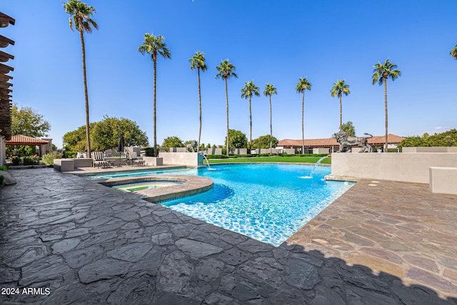 view of pool featuring a gazebo, an in ground hot tub, pool water feature, and a patio