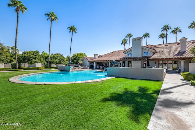 view of pool featuring a patio area and a lawn