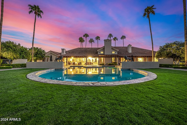 pool at dusk with a lawn