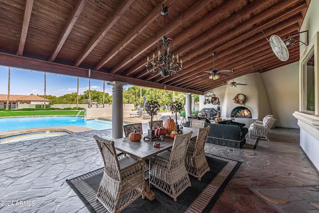 view of patio / terrace featuring ceiling fan, an outdoor living space, and pool water feature