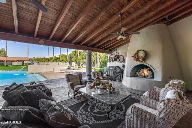 view of patio / terrace with a fenced in pool, ceiling fan, grilling area, and pool water feature