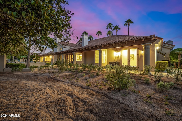 view of back house at dusk