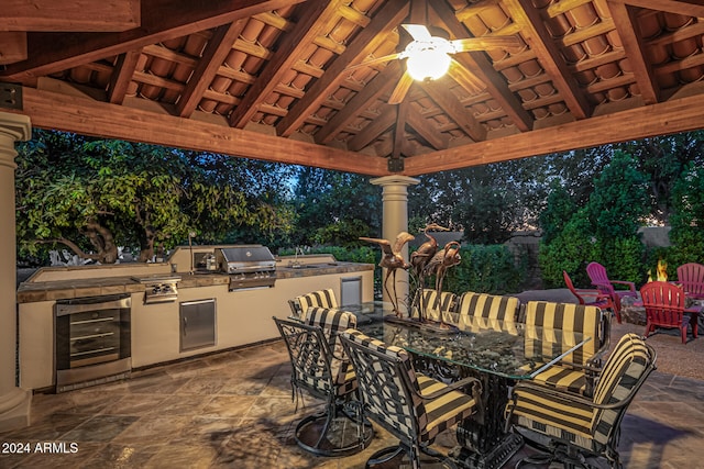 view of patio / terrace with a gazebo, exterior kitchen, area for grilling, sink, and wine cooler