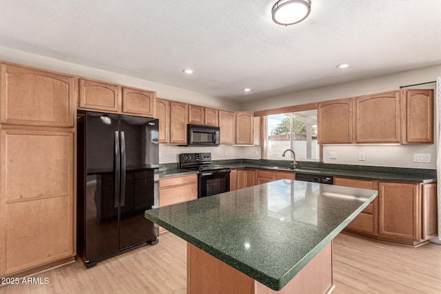 1203 E Bishop Dr, Tempe, AZ 85282 - kitchen with light wood-style flooring, a kitchen island, a sink, and black appliances
