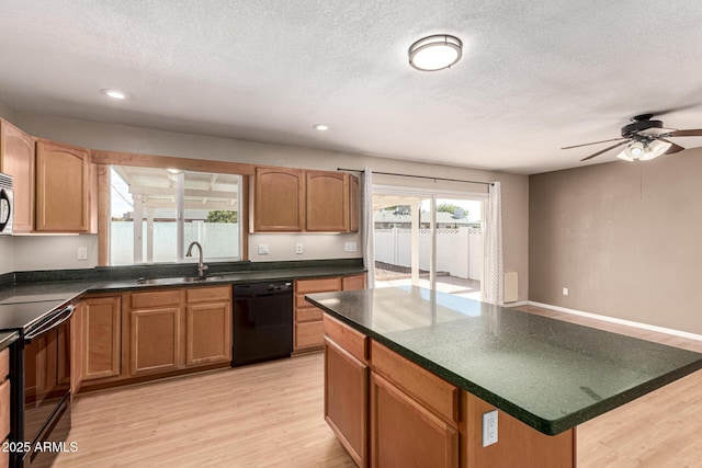 1203 E Bishop Dr, Tempe, AZ 85282 - kitchen featuring a ceiling fan, dark countertops, a sink, black appliances, and light wood-style floors