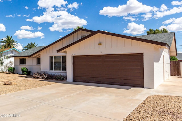 1203 E Bishop Dr, Tempe, AZ 85282 - ranch-style house featuring a garage, board and batten siding, a shingled roof, and driveway