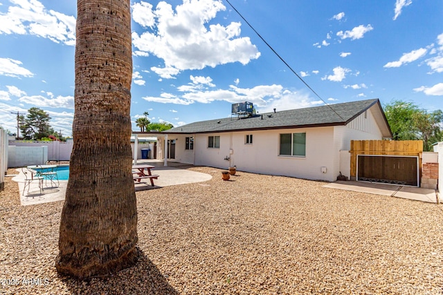 1203 E Bishop Dr, Tempe, AZ 85282 - rear view of property featuring a patio area, central air condition unit, a fenced in pool, a fenced backyard, and a shingled roof