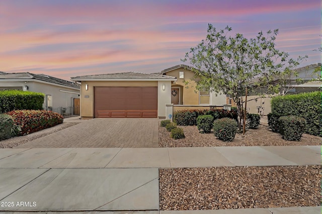 22560 E Rosa Rd, Queen Creek, AZ 85142 - view of front of home featuring decorative driveway, stucco siding, and a garage