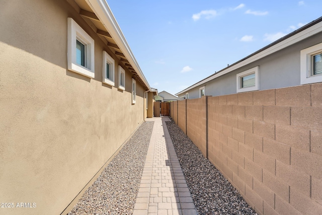 22560 E Rosa Rd, Queen Creek, AZ 85142 - view of side of home featuring stucco siding and a fenced backyard