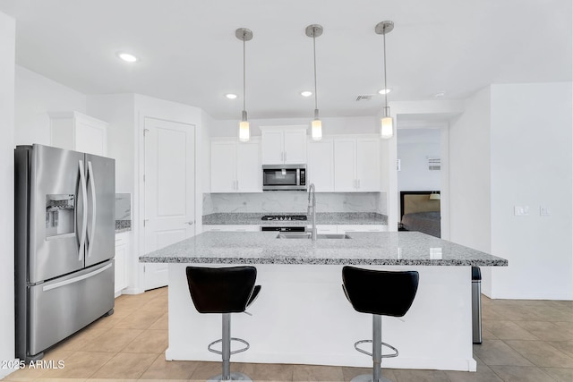 22560 E Rosa Rd, Queen Creek, AZ 85142 - kitchen featuring stainless steel appliances, a sink, white cabinets, light stone counters, and a breakfast bar area