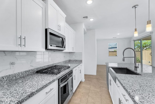 22560 E Rosa Rd, Queen Creek, AZ 85142 - kitchen featuring appliances with stainless steel finishes, a sink, backsplash, white cabinets, and hanging light fixtures