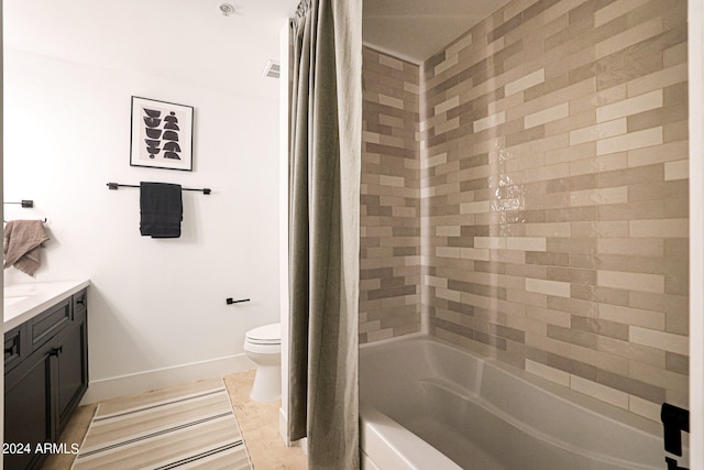 full bathroom featuring tile floors, toilet, vanity, and shower / bath combo