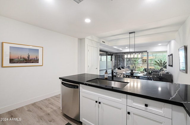 kitchen with stainless steel dishwasher, light hardwood / wood-style floors, decorative light fixtures, white cabinetry, and sink