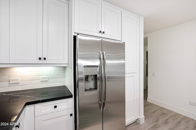 kitchen featuring backsplash, light hardwood / wood-style flooring, high quality fridge, and white cabinetry