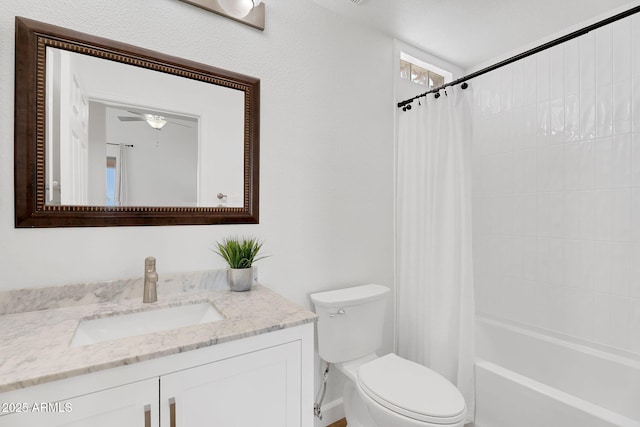 bathroom with toilet, vanity, a ceiling fan, and shower / tub combo