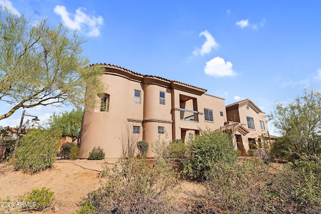 view of home's exterior featuring stucco siding and a tile roof