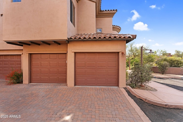 garage with decorative driveway
