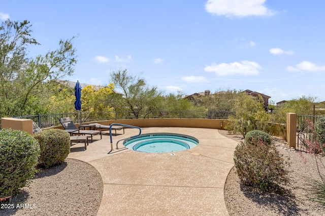 view of swimming pool with an in-ground hot tub, a fenced backyard, and a patio