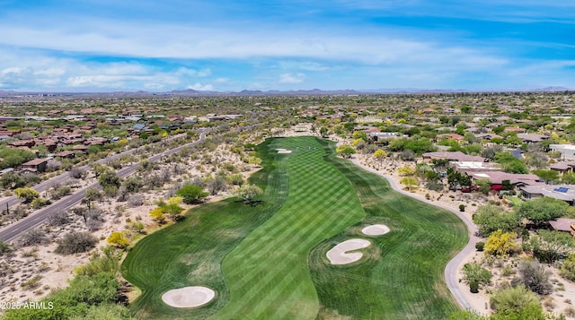 aerial view of residential area with a mountainous background and a golf club