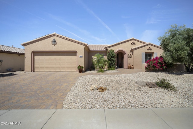 19714 N Concord Dr, Surprise, AZ 85374 - mediterranean / spanish-style house with an attached garage, decorative driveway, stucco siding, and a tile roof