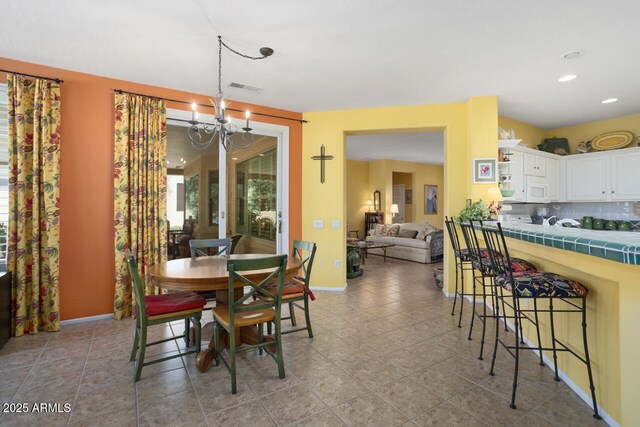 19714 N Concord Dr, Surprise, AZ 85374 - tiled dining room with a chandelier, baseboards, and recessed lighting