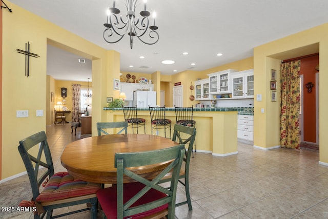 19714 N Concord Dr, Surprise, AZ 85374 - dining area with a chandelier, light tile patterned floors, baseboards, and recessed lighting