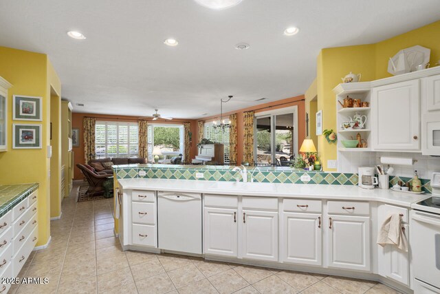 19714 N Concord Dr, Surprise, AZ 85374 - kitchen featuring white appliances, a sink, a peninsula, open floor plan, and white cabinets
