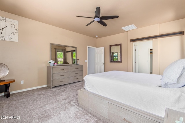 carpeted bedroom with a ceiling fan, visible vents, and baseboards