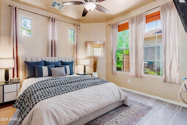 bedroom featuring visible vents, baseboards, and multiple windows