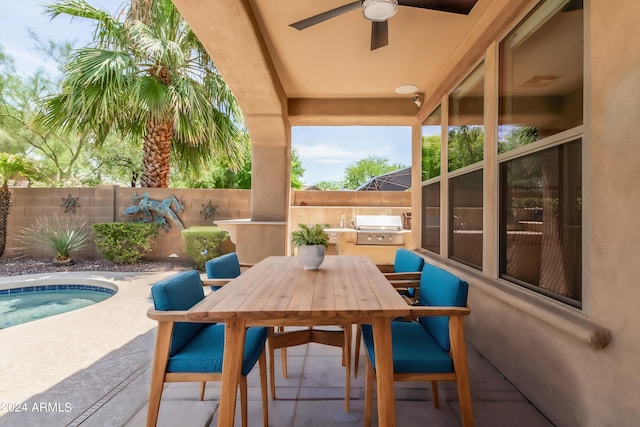 view of patio featuring grilling area, area for grilling, outdoor dining space, ceiling fan, and a fenced backyard