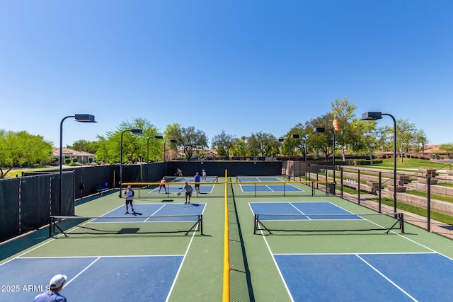 view of tennis court with fence