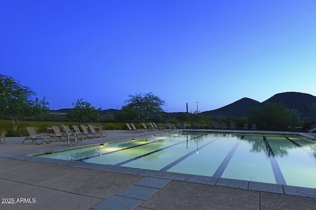 pool with a patio area and a mountain view