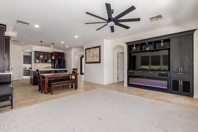 interior space with light tile patterned floors, arched walkways, visible vents, and recessed lighting