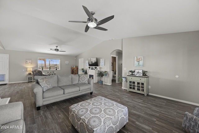 living room with ceiling fan, dark hardwood / wood-style flooring, and vaulted ceiling