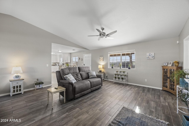 living room featuring dark hardwood / wood-style floors, ceiling fan, and lofted ceiling