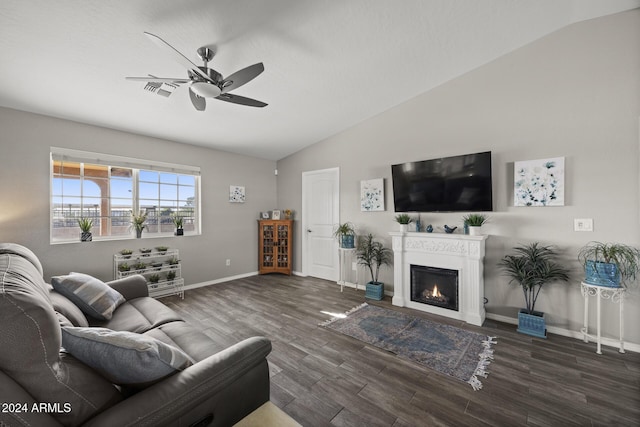 living room featuring ceiling fan, lofted ceiling, and dark wood-type flooring