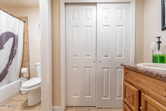 full bathroom featuring tile patterned floors, vanity, shower / bath combination with curtain, and toilet