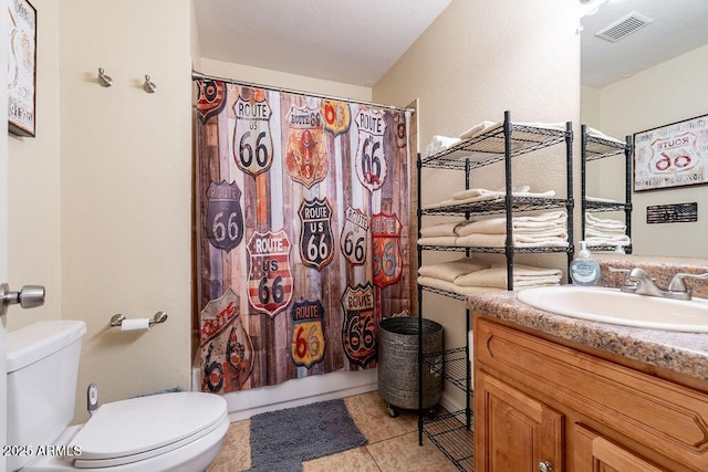 full bathroom featuring tile patterned floors, vanity, toilet, and shower / tub combo